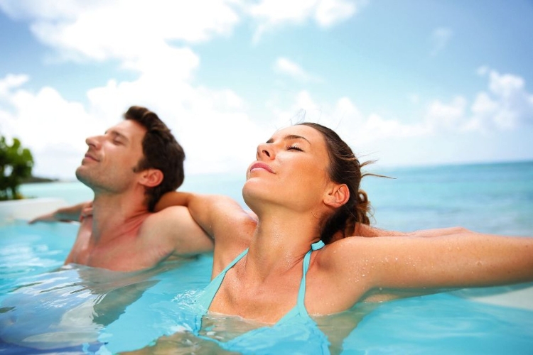 Couple relaxing in swimming pool