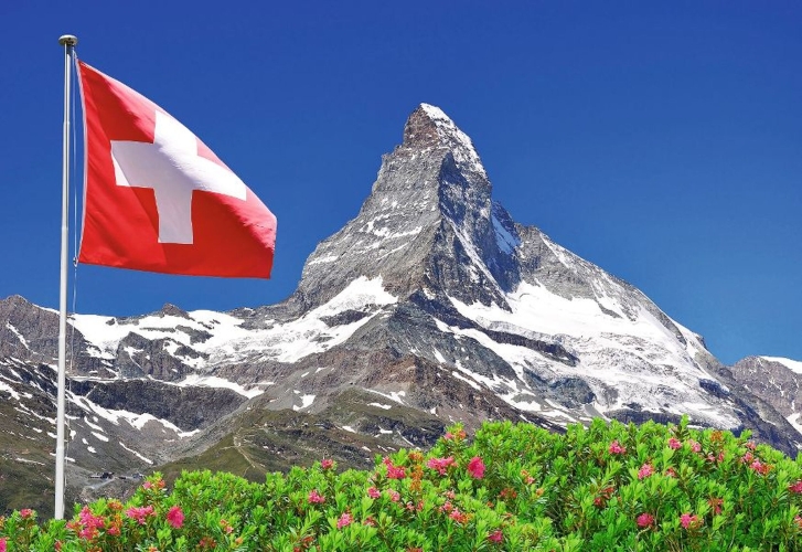 Beautiful mountain Matterhorn with Swiss flag - Swiss Alps