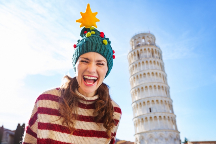 Happy woman in Christmas tree hat near Leaning Tour of Pisa